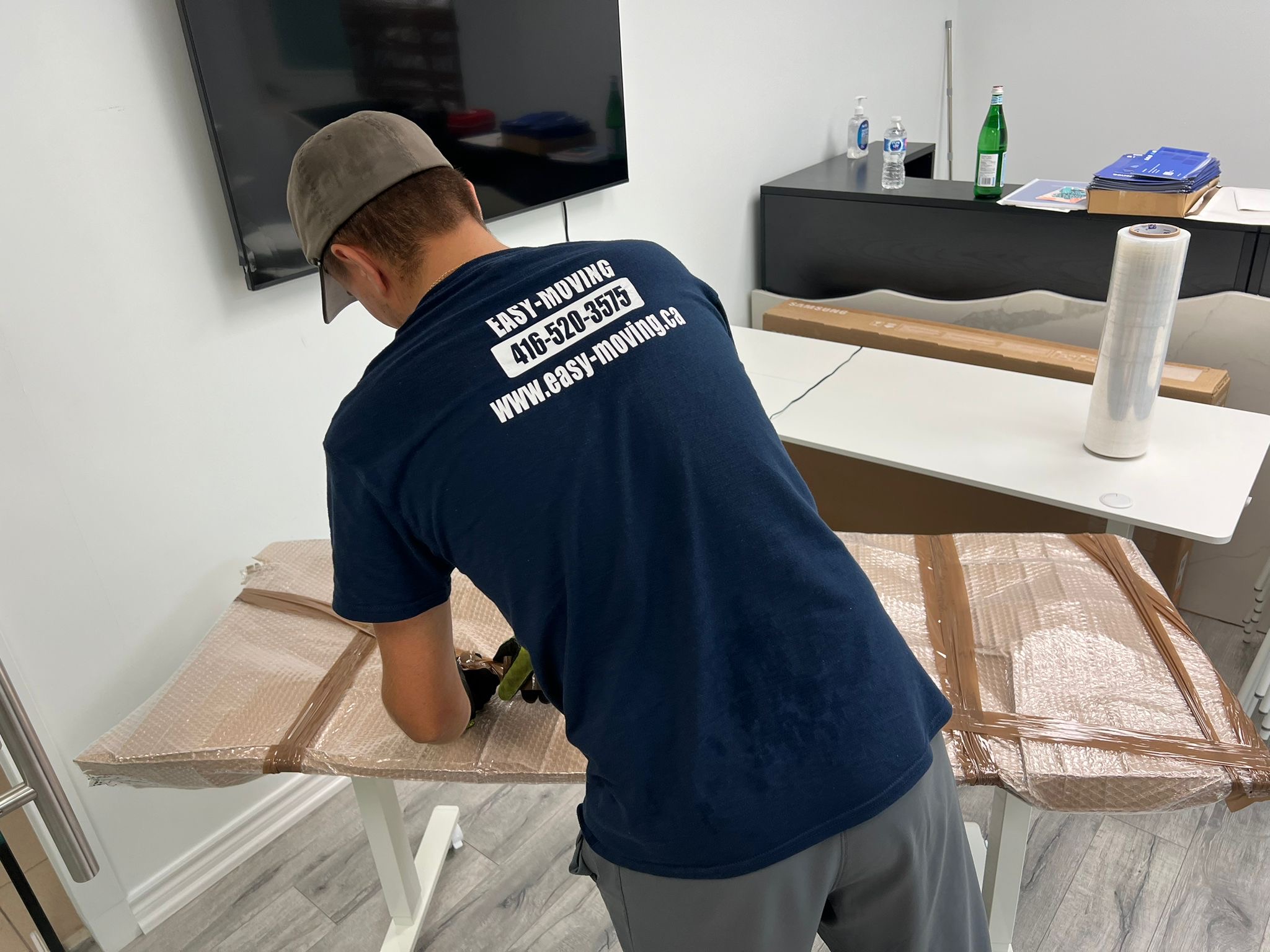 Easy Moving crew preparing furniture for a move